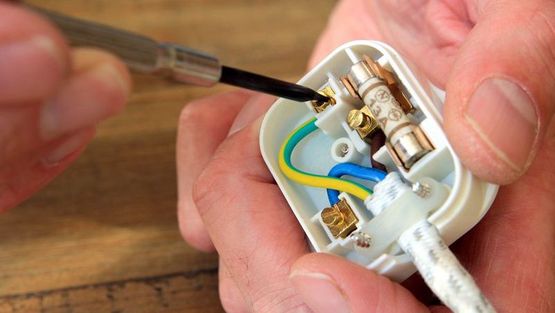 An electrician fixing a fuse
