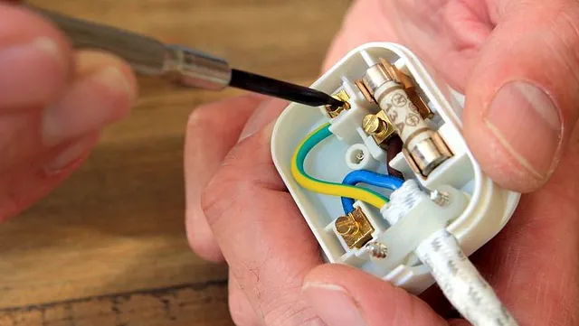 An electrician fixing a fuse